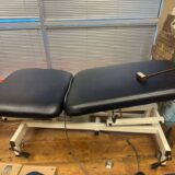 Adjustable elevating massage/exam table